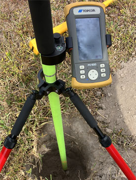 Topcon FC-500 data collector mounted on tripod conducting land survey over utility hole in Sunrise by Land Roadway Solutions